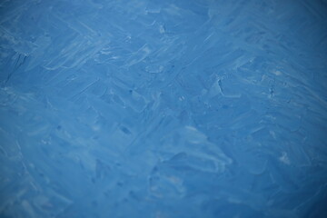 Textured dried blue oil paints. The texture of the painting. Close-up of dried oil paint patterns on an old wooden palette.