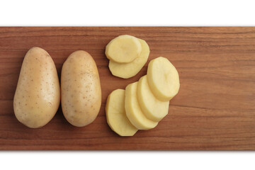 Raw potatoes with slices on wooden chopping board isolated on white background, Top view.