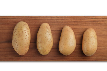 Raw potatoes on wooden chopping board isolated on white background, Top view, Clipping path.