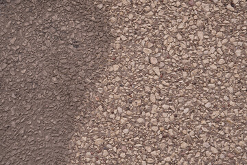 stone wall texture close up. one side is painted with dark paint, the other with light paint.