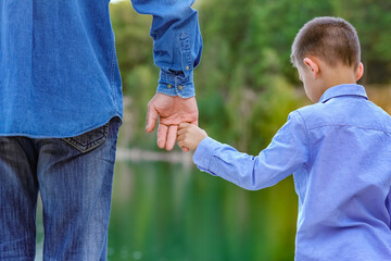 A Hands of parent and child in nature in the park travel