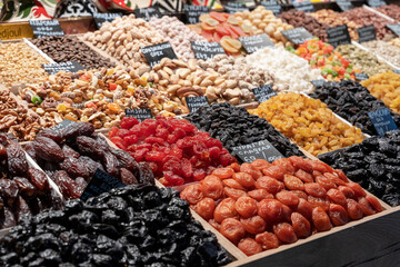 Market counter with various assorted dried fruits and nuts. Healthy food. Local market place.
