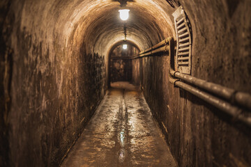 Fototapeta na wymiar long dark narrow underground tunnel with lighting