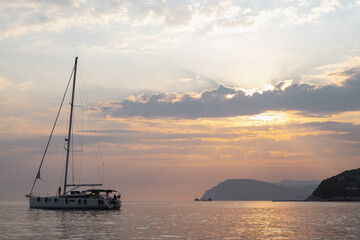 Yacht at sea at sunset. Yachting, luxury Sailing theme.