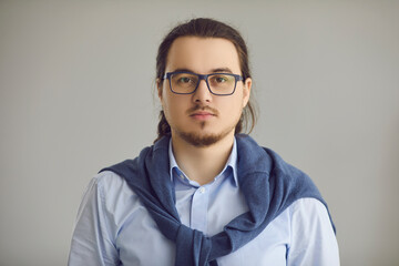 Studio headshot portrait of intelligent nerdy man in office shirt and glasses with moustache and...