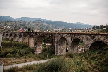 Fototapeta na wymiar Old railway bridge, old viaduct Vorokhta, Ukraine. Carpathian Mountains, wild mountain landscape