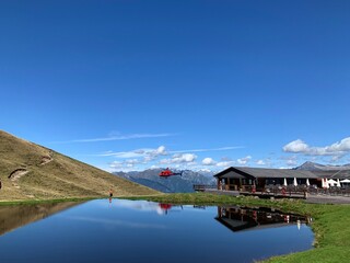 Naklejka premium helicopter by the lake in the mountains