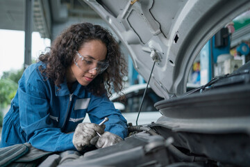 Auto mechanic hands using wrench to repair a car engine. Auto mechanic female automotive diagnostic Checking car service, repair, maintenance.