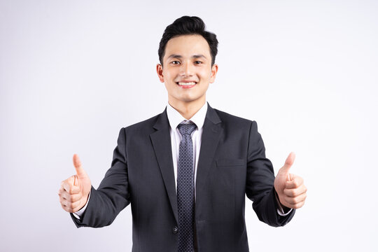 Image of young Asian businessman wearing suit on white background
