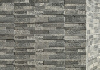  Elegant stone cladding wall made of gray granite panels with different shades and shapes. Background and texture.	