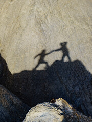 Shadow of two people on rock mountain