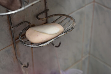Old soap On the shelf in the bathroom.