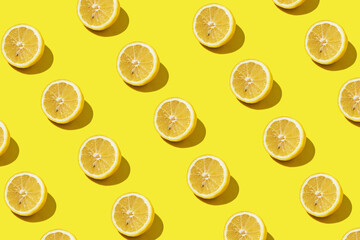 Trending modern pattern with lemon slices on yellow background illuminated by bright summer sunlight - Pop art design minimal creative concept - Fresh fruits