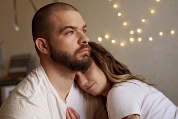 Fototapeta premium Couple in love embracing and cuddling at the bedroom