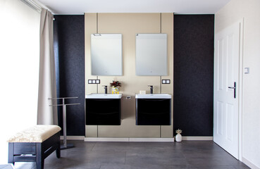 Modern Bathroom interior with gold metallic brushed brass wall and with black sinks. Contemporary bathroom with copy space. front view