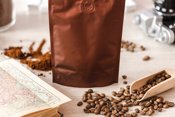 Blank coffee packaging with coffee seeds, book and glass jar with ground coffee, coffee packaging...