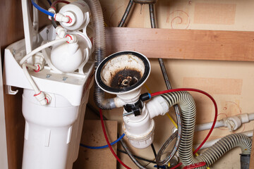 Broken sink in the kitchen. Clogged sink drain. Plumbing services. Drain and osmotic water...