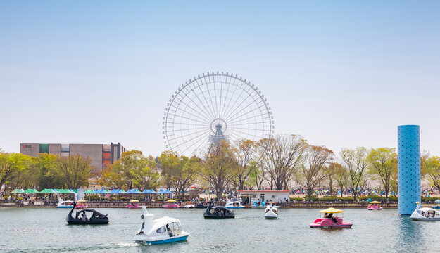 Pedal boats in Yume-no-ike (Dream Pond) and Expo '70 Pavilion in Expo '70 Commemorative Park, and Redhorse Osaka Wheel in Expocity in Osaka, Japan