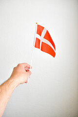 Hand holding hand flag of Danmark