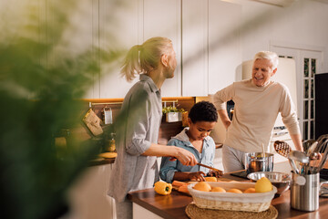 Family and cute little son cooking in modern kitchen together