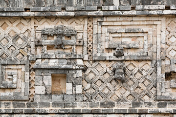 Fototapeta na wymiar Ornate decoration at wall of Mayan Nunnery Square ruins at Uxmal, Yucatan, Mexico