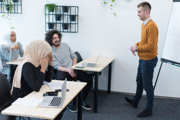 Group of people listening to a presentation speech and working and communicating together in creative office
