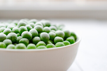 Fresh frozen peas in white bowl. with copy space