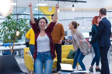 Business winners. Full length of group of happy young people in formal wear celebrating, gesturing, keeping arms raised and expressing positivity © as-artmedia