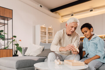 Fototapeta premium Family of father and son looking feeling concentrated while making plane model