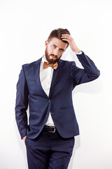 Elegant young handsome man in black classic costume. Studio fashion portrait.