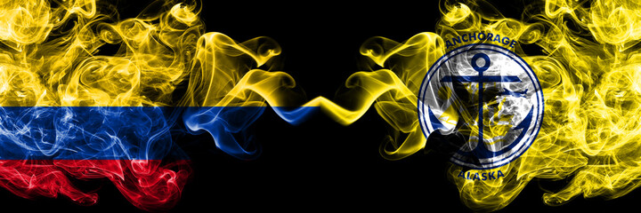 Obraz premium Colombia, Colombian vs Anchorage, Alaska smoky mystic flags placed side by side. Thick colored silky abstract smokes flags.