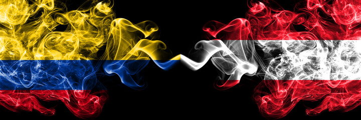 Colombia, Colombian vs Austria, Austrian smoky mystic flags placed side by side. Thick colored silky abstract smokes flags.