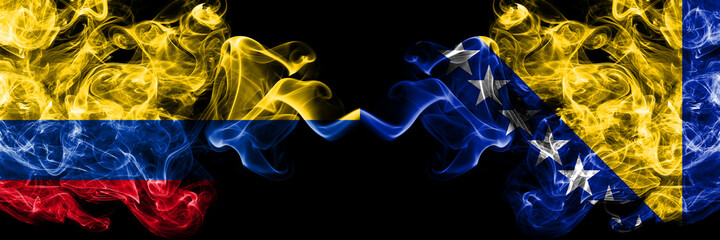 Colombia, Colombian vs Bosnia and Herzegovina, Bosnian, Herzegovinian smoky mystic flags placed side by side. Thick colored silky abstract smokes flags.