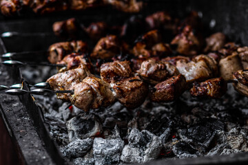 Fresh shish kebab on skewers is fried on the grill. Grilled meat on skewers.