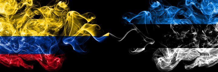 Colombia, Colombian vs Estonia, Estonian smoky mystic flags placed side by side. Thick colored silky abstract smokes flags.