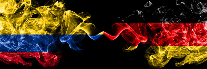 Colombia, Colombian vs Germany, German, Deutschland smoky mystic flags placed side by side. Thick colored silky abstract smokes flags.