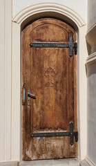 an old wooden door with a cross engraved on it
