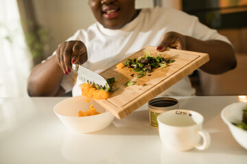 Multiracial woman is cooking natural healthy food