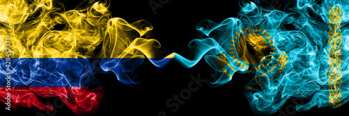 Colombia, Colombian vs Kazakhstan, Kazakhstani smoky mystic flags placed side by side. Thick colored silky abstract smokes flags.