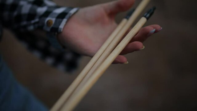 girl holding training arrows in her hands, close-up. arrows in the hands of a girl close-up