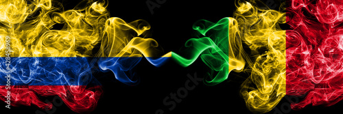 Colombia, Colombian vs Mali smoky mystic flags placed side by side. Thick colored silky abstract smokes flags.