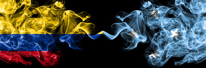 Colombia, Colombian vs Micronesia smoky mystic flags placed side by side. Thick colored silky abstract smokes flags.