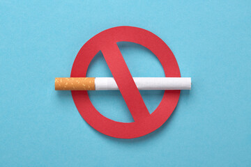 No smoking icon. Red forbidden sign with a cigarette on blue. No tobacco day, no smoking concept. - obrazy, fototapety, plakaty