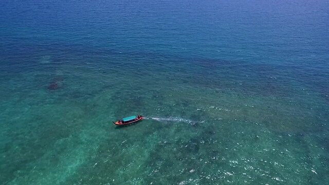 Aerial view shot drone Long Boat moored in the sea, bright emerald green water, tourism, snorkeling, White sand beach travel summer Thailand