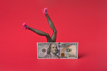 Sexy woman legs in black fishnet stockings over dollar bill. Sex for money concept. Red background, copy space.