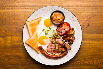 Top view photo of morning tasty english breakfast in restaurant over wooden table