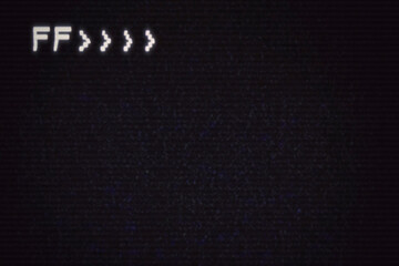 Intentional distortion and noise on the screen from an old VHS tape, with the letters FF (fast forward) in the upper left corner.

