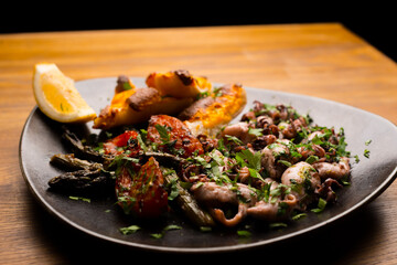 Photo of beautiful plate with grilled octopus