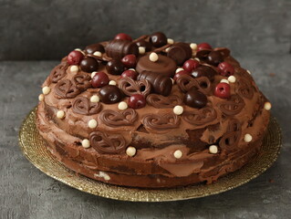 Birthday chocolate cake decorated with chocolates and cherries