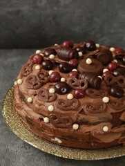 Birthday chocolate cake decorated with chocolates and cherries